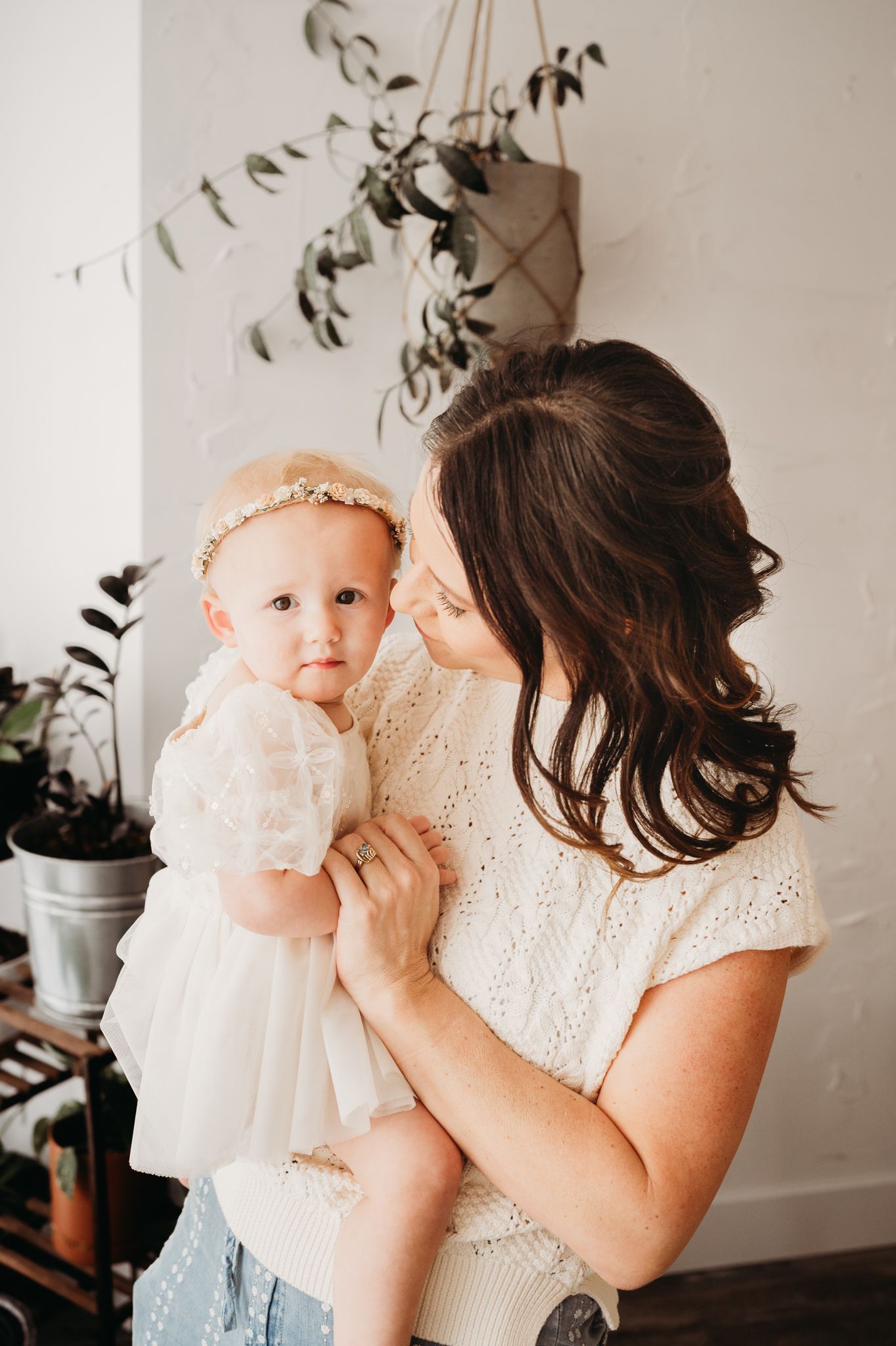 A momma snuggles tightly with her baby girl during milestone session in bismarck the lifestyle studio of Nikii Pix Photography
